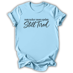 A light blue short-sleeve t-shirt printed with the “Still Tired Nutcracker Mom” graphic design.
