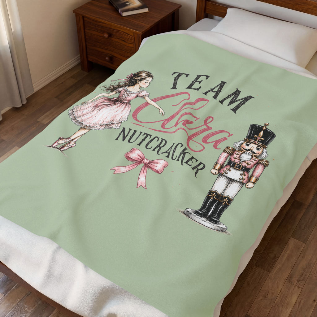 A personalized bedding set featuring a light sage green duvet cover with a 'Team Sara Nutcracker' graphic, styled on a bed in a bedroom setting.