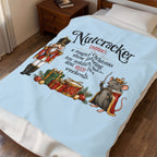 A light blue bedding set, including a comforter and matching pillowcase, styled on a bed in a bedroom. The comforter features a festive Christmas-themed graphic with a nutcracker, a mouse dressed as a king, and a definition of the word 'Nutcracker'.